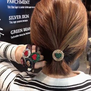 Elastic hair ties with multicolored rhinestone.